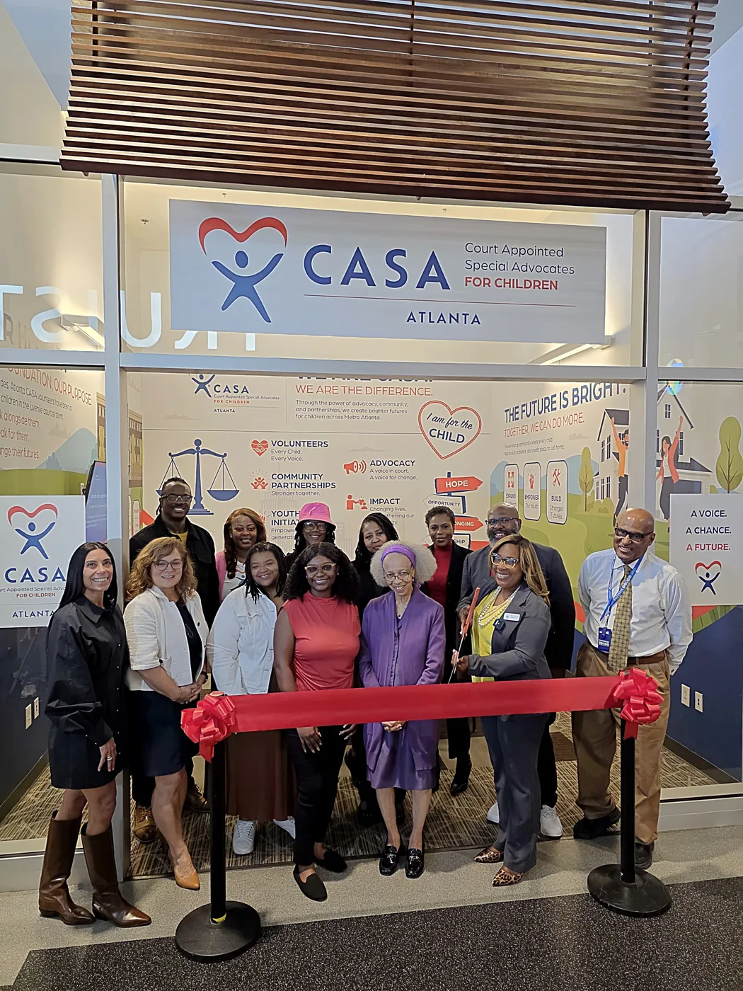Atlanta CASA staff and supporters cut the ribbon on the nonprofit's storefront at JA Finance Park
