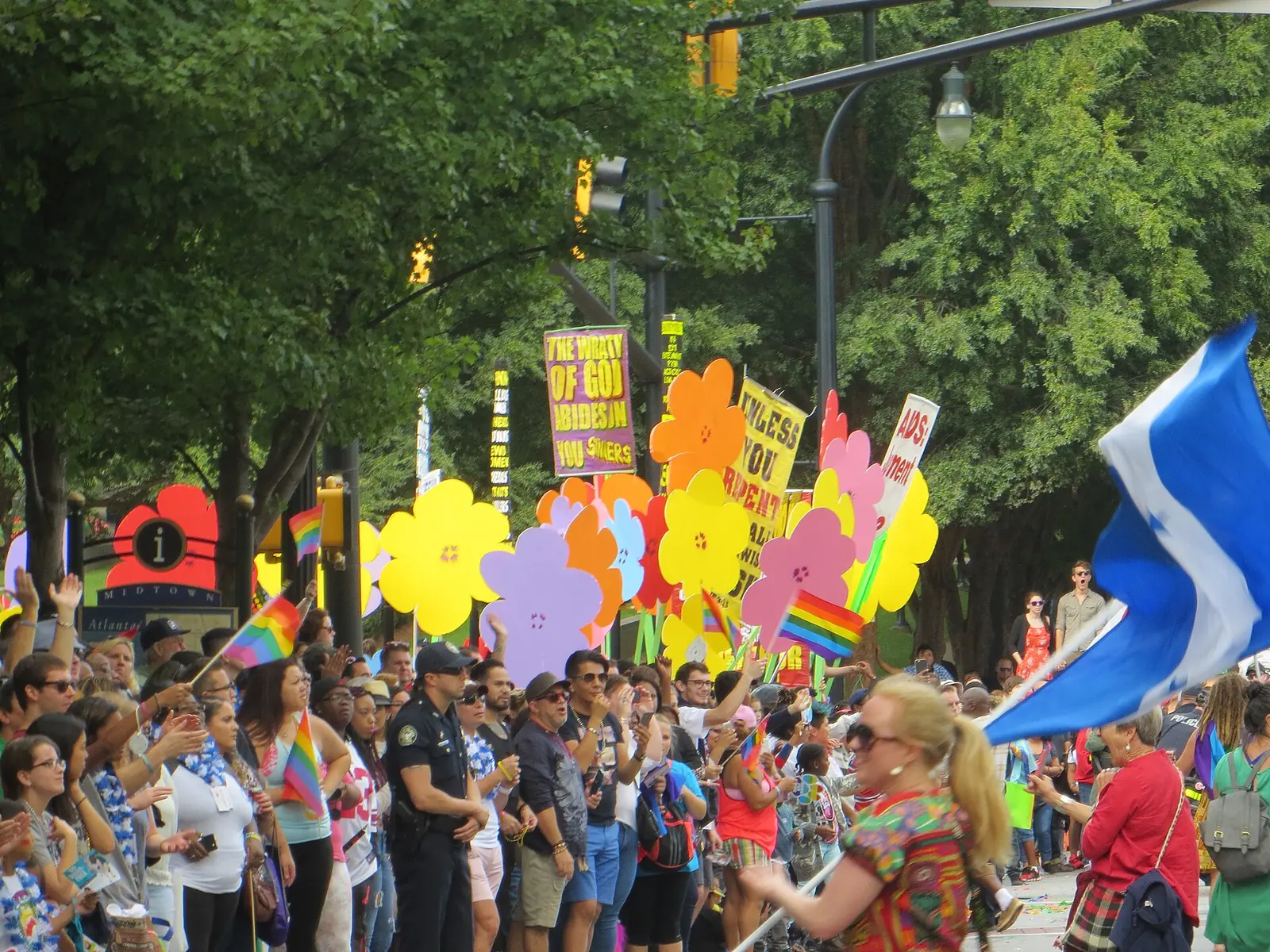 Marchers with rainbow flags and flowers in the Atlanta Pride Parade