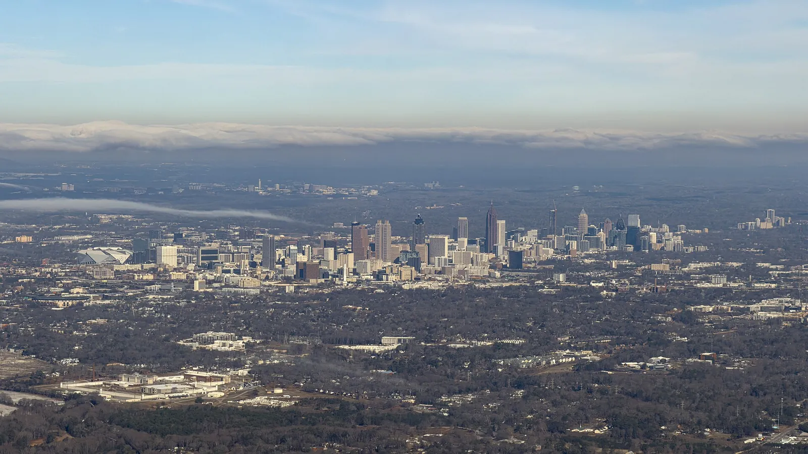Downtown and Midtown Atlanta seen from the air, with the city's tree canopy around them