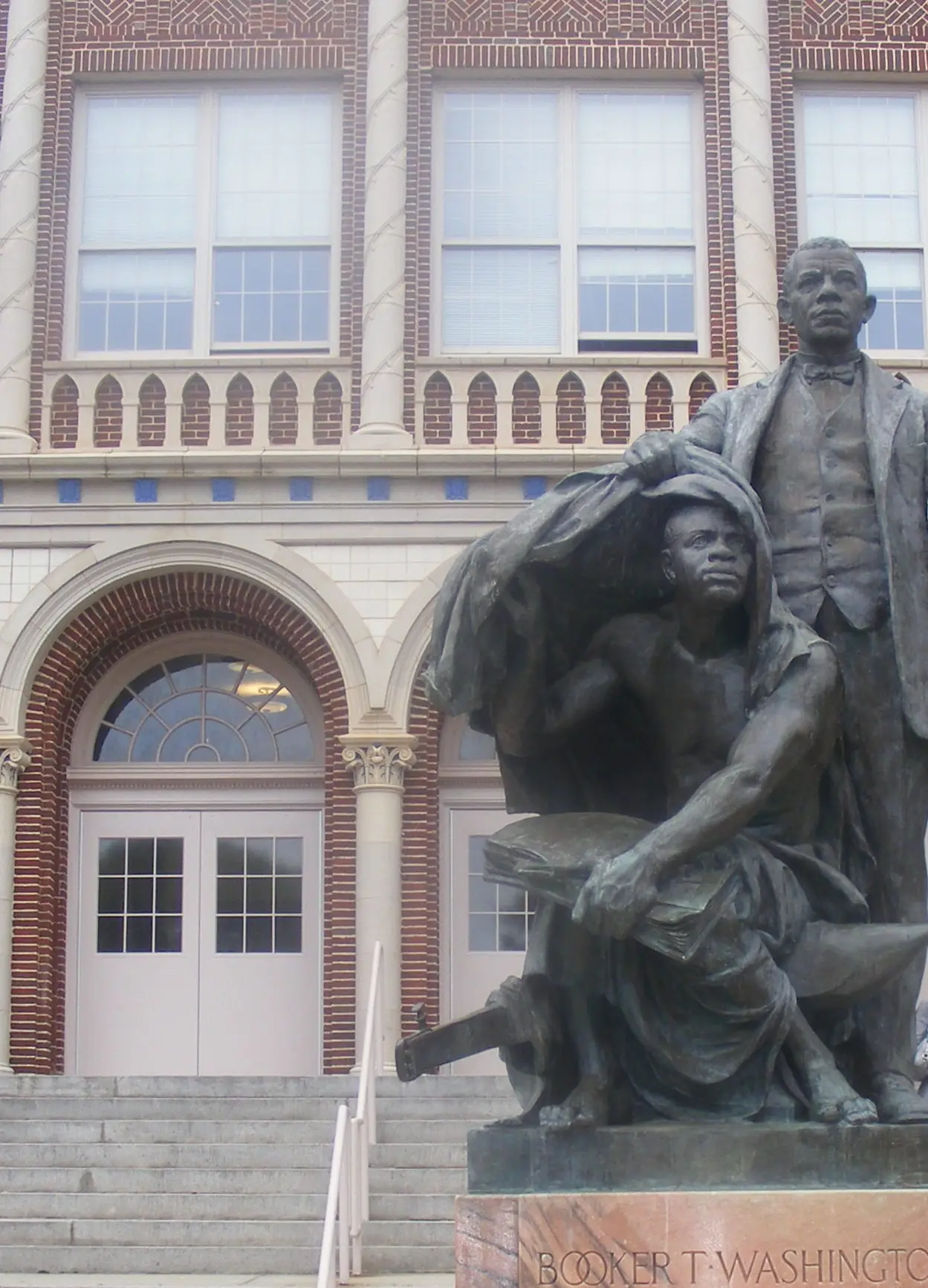 The statue of Booker T. Washington in front of Booker T. Washington High School
